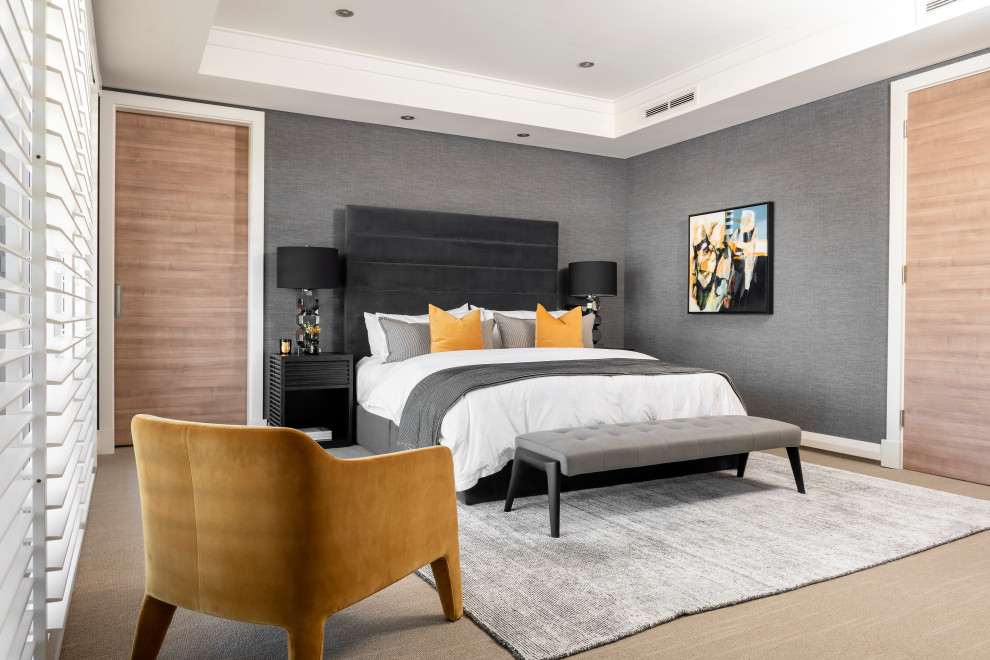 Large contemporary master bedroom in Sydney with grey walls and beige floor.