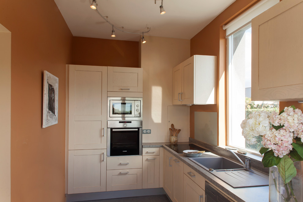 This is an example of a small transitional l-shaped separate kitchen in Other with a drop-in sink, shaker cabinets, light wood cabinets and no island.