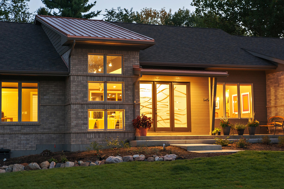 Design ideas for a large modern one-storey brick brown exterior in Cincinnati with a hip roof.