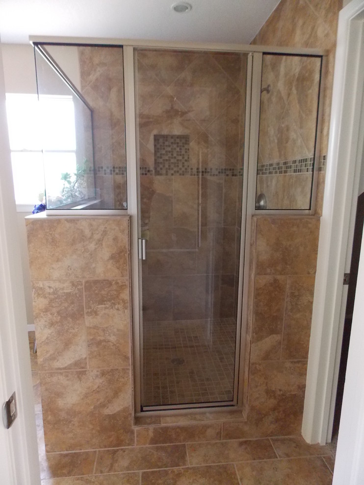 Photo of a mid-sized traditional master bathroom in Austin with an undermount sink, flat-panel cabinets, medium wood cabinets, granite benchtops, a corner shower, a two-piece toilet, multi-coloured tile, ceramic tile, beige walls and ceramic floors.