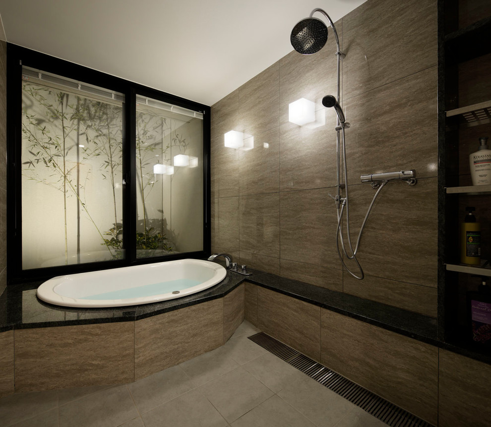 This is an example of a contemporary bathroom in Other with open cabinets, a corner tub, an open shower, grey walls, grey floor and an open shower.