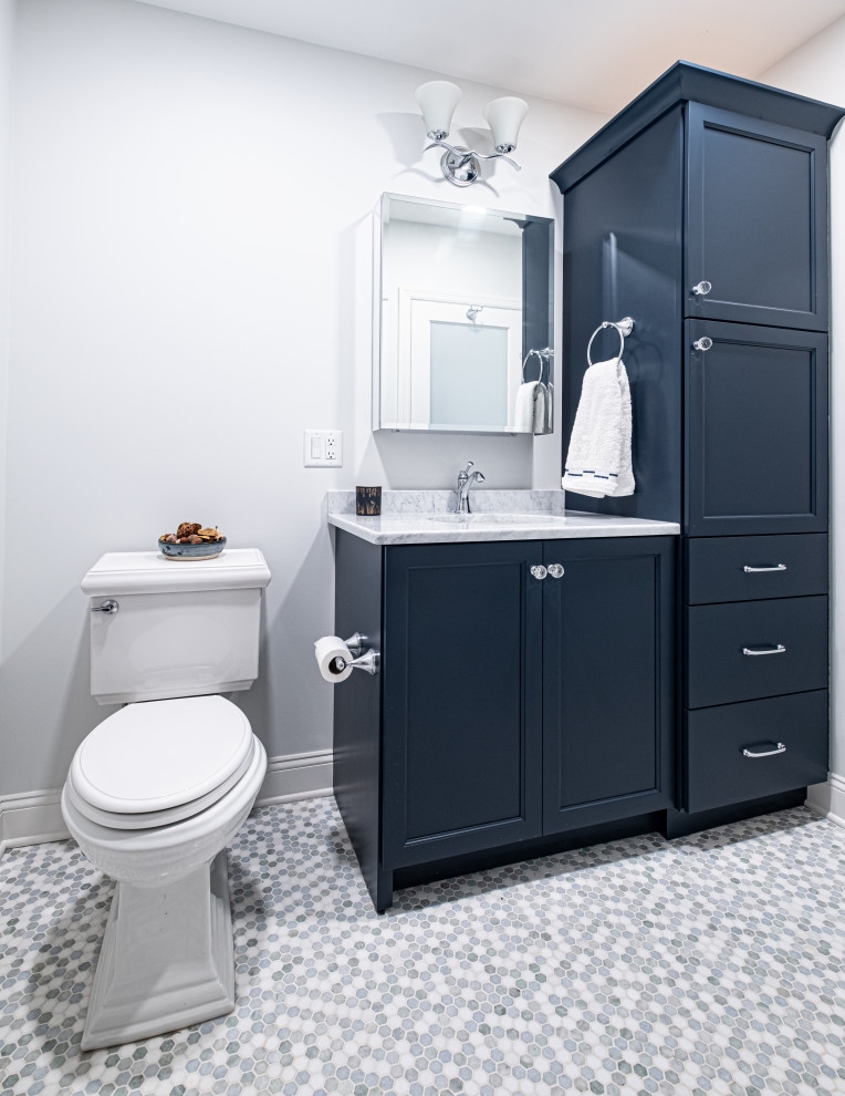 Photo of a mid-sized 3/4 bathroom in Newark with recessed-panel cabinets, blue cabinets, an alcove shower, a two-piece toilet, mosaic tile floors, an undermount sink, engineered quartz benchtops, a shower curtain, white benchtops, a niche, a single vanity and a built-in vanity.