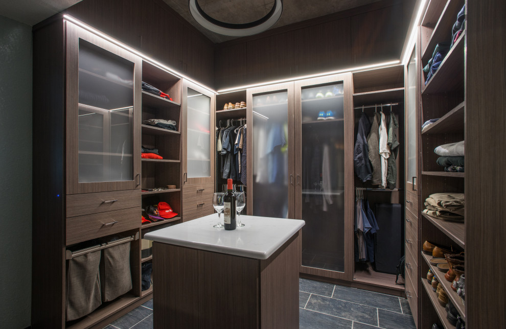 Inspiration for a mid-sized modern men's walk-in wardrobe in Denver with flat-panel cabinets, medium wood cabinets, ceramic floors, grey floor and vaulted.