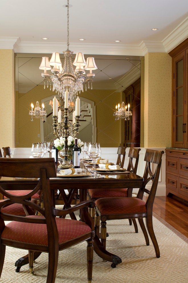 Design ideas for a transitional dining room in Boston with yellow walls and medium hardwood floors.