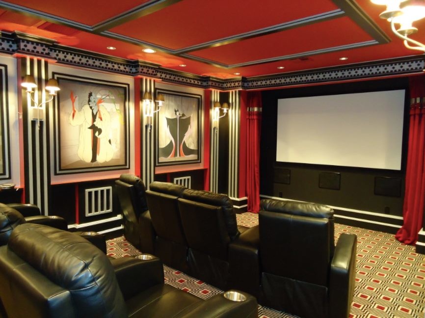 Photo of a mid-sized traditional enclosed home theatre in Houston with red walls, carpet and a projector screen.