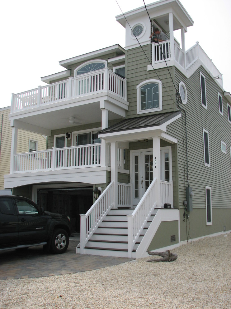 Mid-sized beach style two-storey green exterior in New York with vinyl siding.