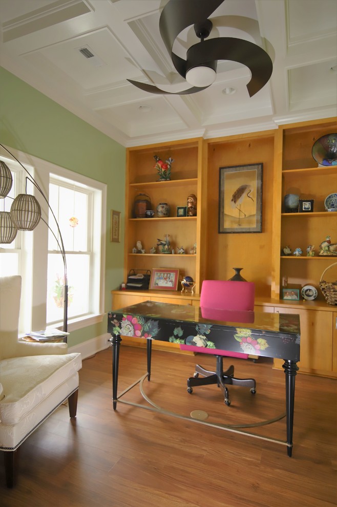 Photo of a mid-sized asian home office in Raleigh with a library, green walls, vinyl floors, no fireplace, a freestanding desk and brown floor.