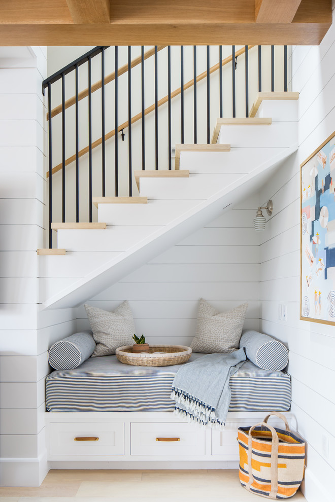 Inspiration for a beach style wood staircase in Orange County with metal railing.