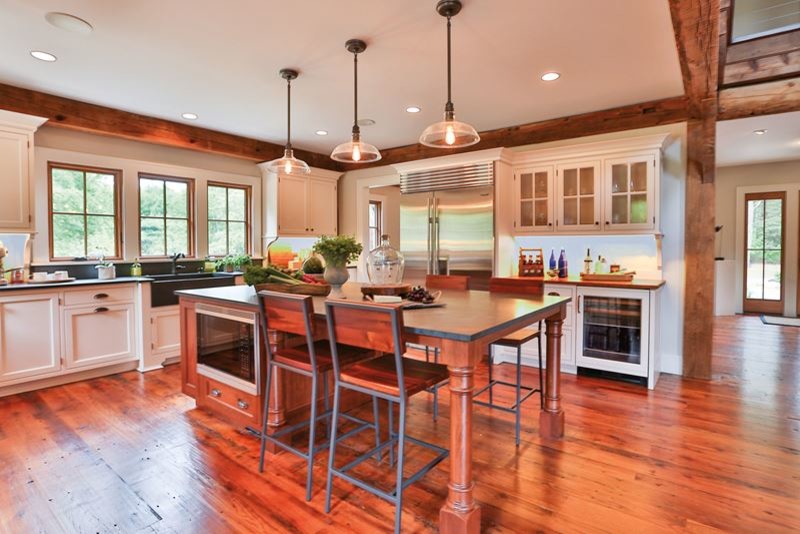 Eat-in kitchen - mid-sized transitional u-shaped medium tone wood floor eat-in kitchen idea in Denver with a farmhouse sink, shaker cabinets, white cabinets, concrete countertops, black backsplash, cement tile backsplash, black appliances and an island