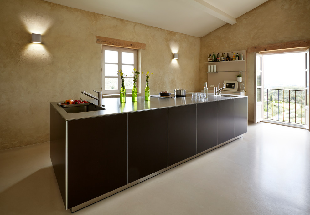 This is an example of a mid-sized mediterranean single-wall separate kitchen in Cheshire with with island and black cabinets.