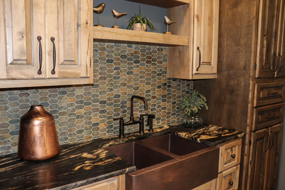 Kitchen - mid-sized rustic single-wall porcelain tile and brown floor kitchen idea with a double-bowl sink, raised-panel cabinets, granite countertops, multicolored backsplash, slate backsplash, black countertops and light wood cabinets