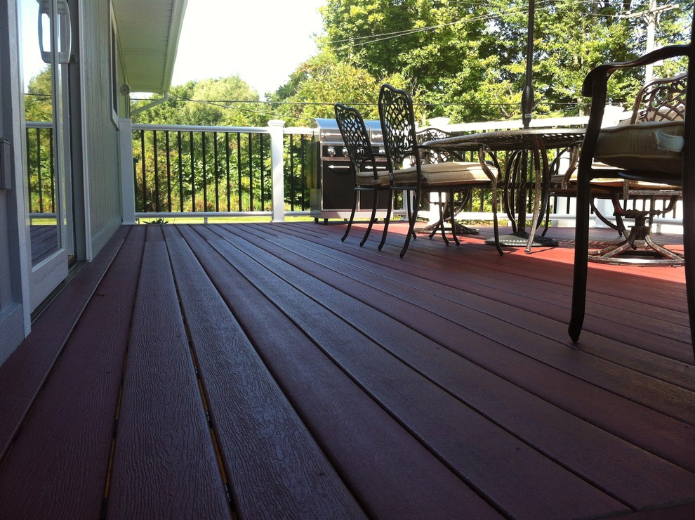 This is an example of a traditional backyard deck in Grand Rapids with an awning.