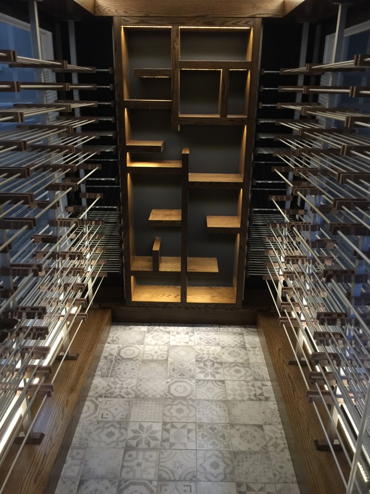 Design ideas for a mid-sized contemporary wine cellar in Toronto with storage racks, ceramic floors and white floor.