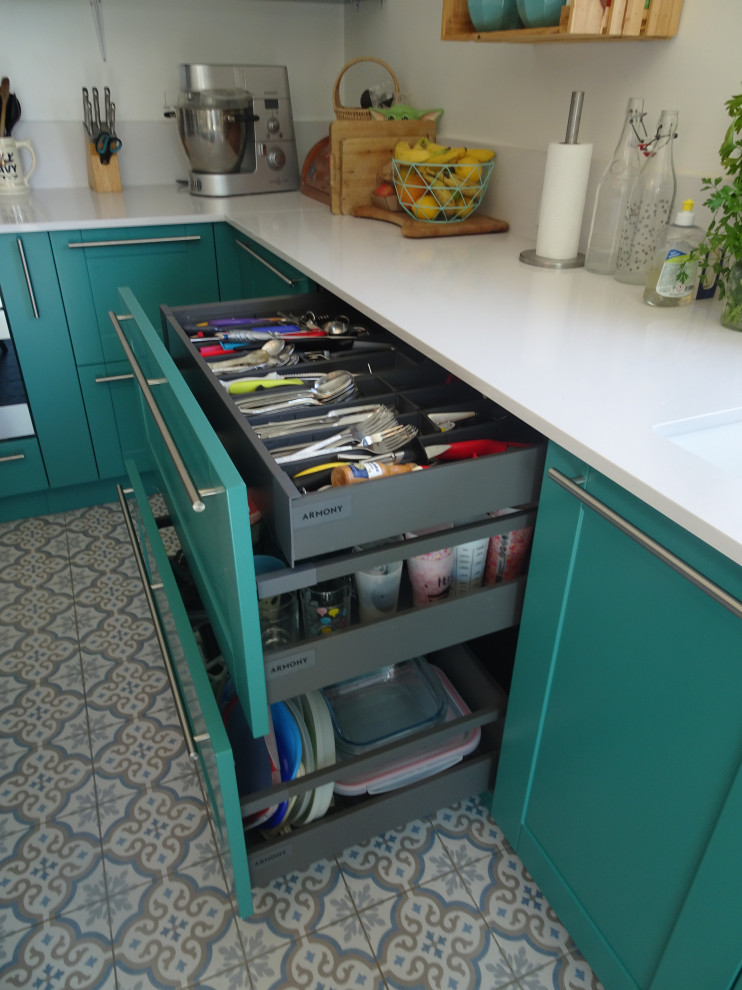 This is an example of a large traditional l-shaped open plan kitchen in Marseille with an undermount sink, recessed-panel cabinets, turquoise cabinets, quartzite benchtops, white splashback, stainless steel appliances, cement tiles, no island, blue floor and white benchtop.