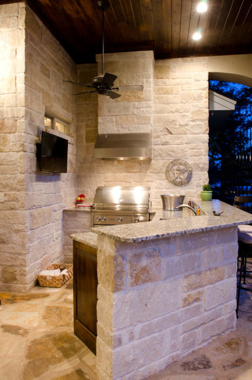 Expansive traditional two-storey white exterior in Austin with stone veneer.