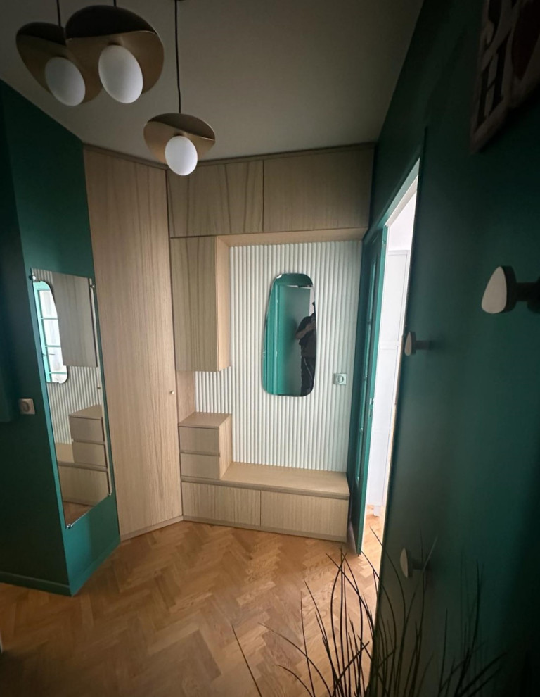 Photo of a small contemporary foyer in Paris with green walls, light hardwood floors, a double front door, a green front door, beige floor and wood walls.