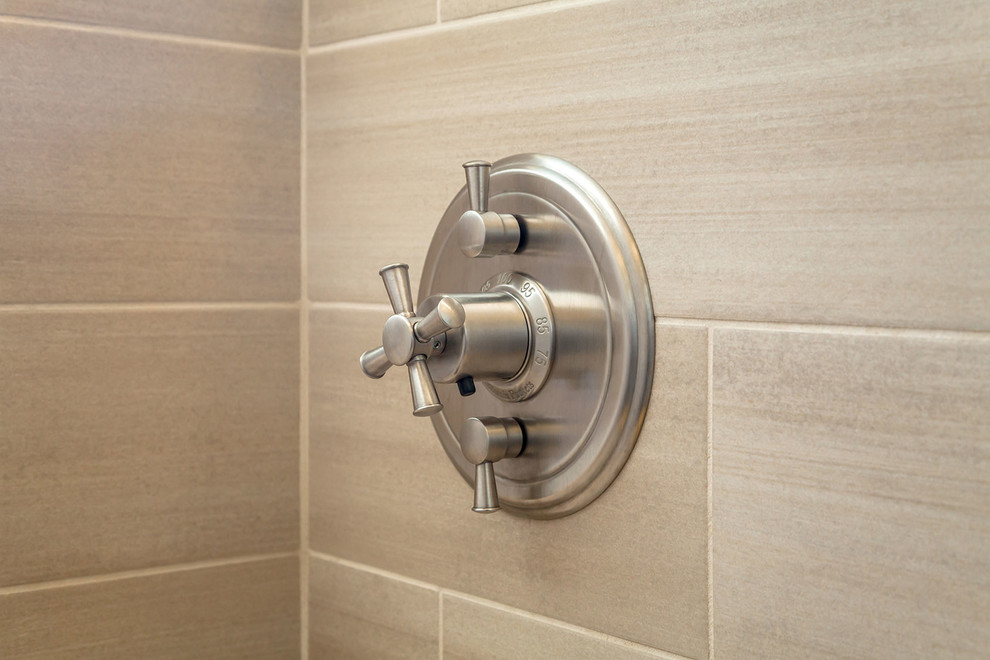 Inspiration for a large transitional master brown tile and porcelain tile ceramic tile walk-in shower remodel in Phoenix with recessed-panel cabinets, dark wood cabinets, a two-piece toilet, beige walls, an undermount sink and granite countertops