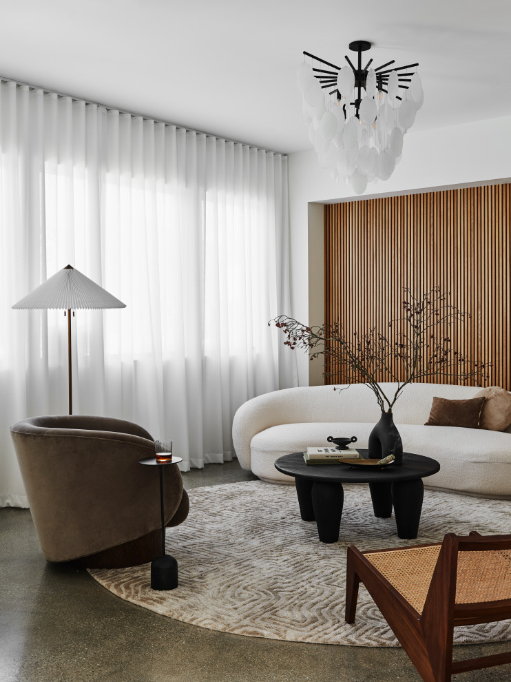Immagine di un soggiorno moderno con pareti bianche, pavimento in cemento, pavimento grigio e pareti in legno
