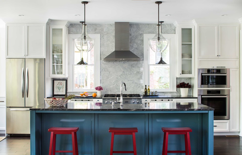 Inspiration for a mid-sized transitional kitchen in Atlanta with recessed-panel cabinets, white cabinets, solid surface benchtops, grey splashback, stone tile splashback, stainless steel appliances, dark hardwood floors and with island.