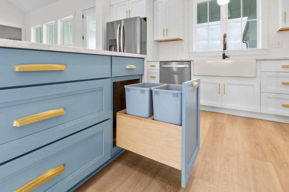 Example of a large transitional l-shaped open concept kitchen design in Richmond with a farmhouse sink, recessed-panel cabinets, quartz countertops, white backsplash, stainless steel appliances, an island and white countertops