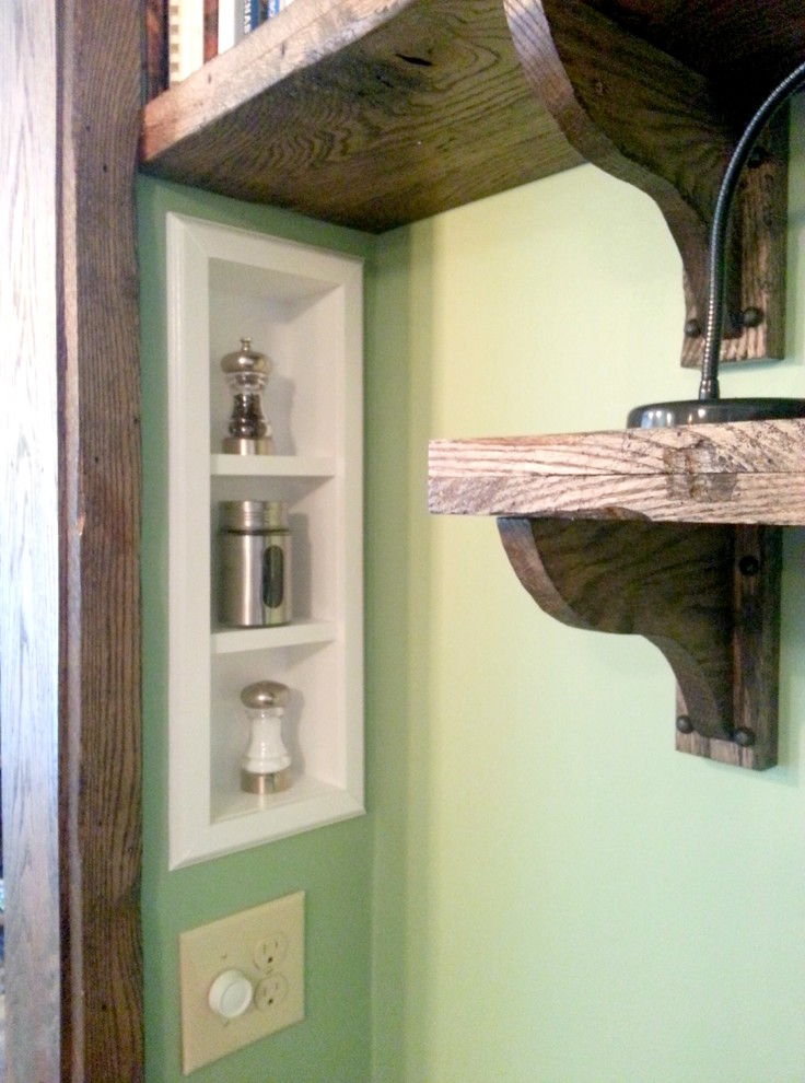 Example of a small mountain style eat-in kitchen design with a farmhouse sink, white cabinets, stainless steel appliances and an island