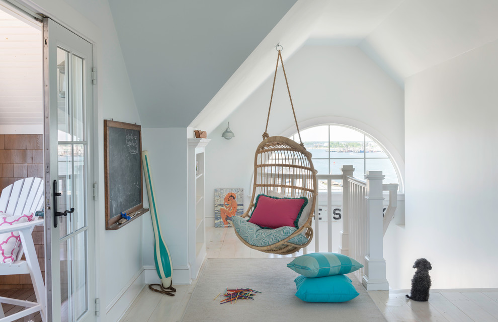 Small beach style kids' room in Providence with white walls and light hardwood floors.