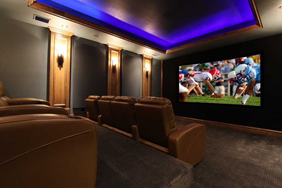 Inspiration for a large transitional enclosed home theatre in Dallas with grey walls, carpet and a projector screen.