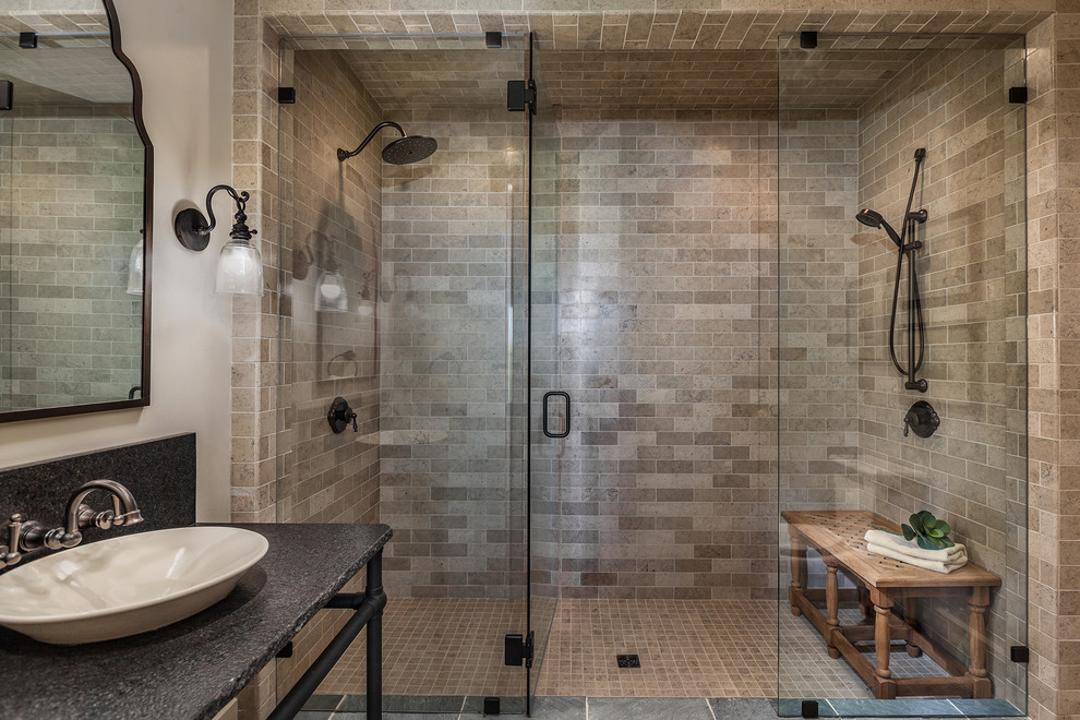 This is an example of a mid-sized mediterranean 3/4 bathroom in Other with open cabinets, black cabinets, a double shower, beige tile, beige walls, a vessel sink, granite benchtops, a one-piece toilet, ceramic floors, multi-coloured floor, a hinged shower door and subway tile.