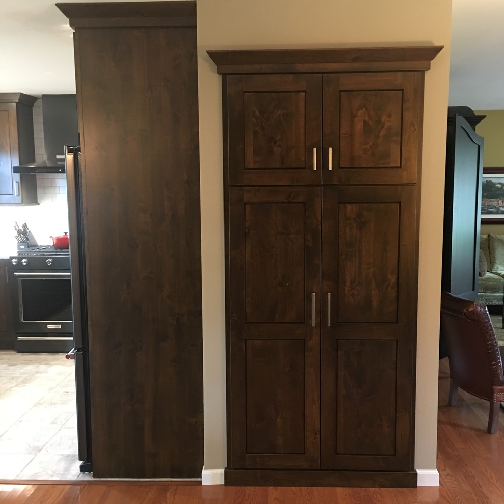 Enclosed kitchen - large transitional l-shaped travertine floor and beige floor enclosed kitchen idea with a double-bowl sink, shaker cabinets, dark wood cabinets, marble countertops, white backsplash, subway tile backsplash, black appliances and an island