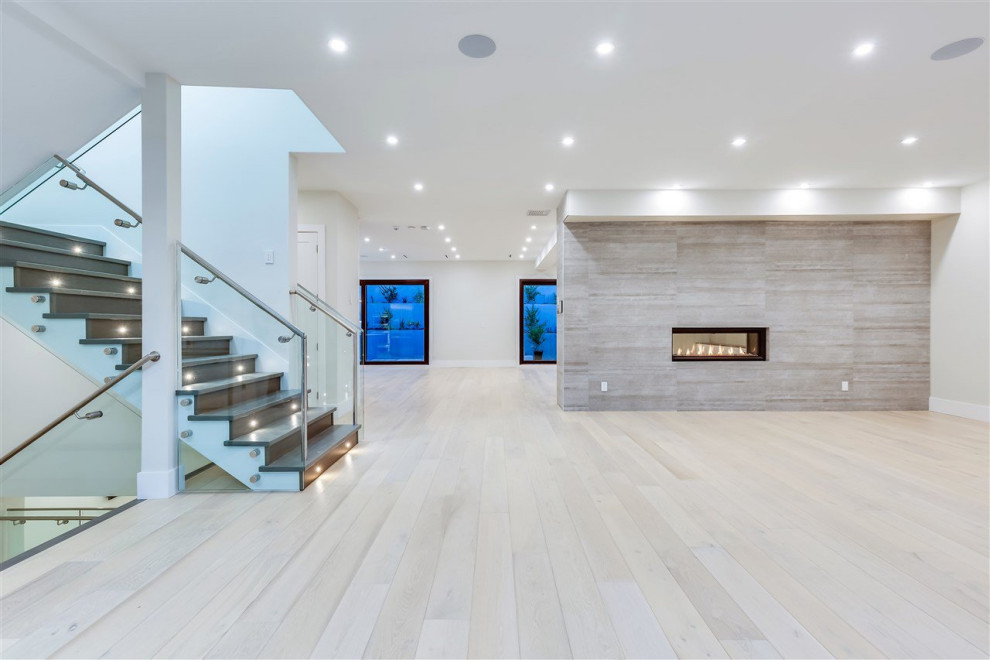 This is an example of a mid-sized modern foyer in Vancouver with light hardwood floors and beige floor.