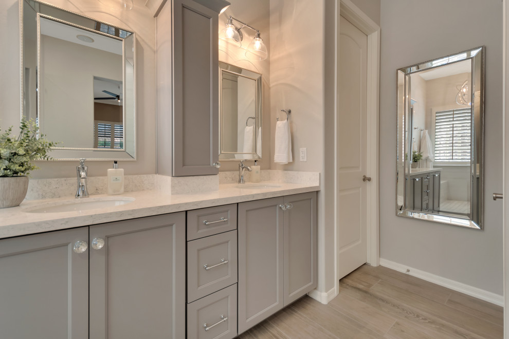 Inspiration for a mid-sized transitional master white tile and porcelain tile wood-look tile floor, multicolored floor and double-sink doorless shower remodel in Phoenix with shaker cabinets, gray cabinets, gray walls, an undermount sink, granite countertops, white countertops and a niche