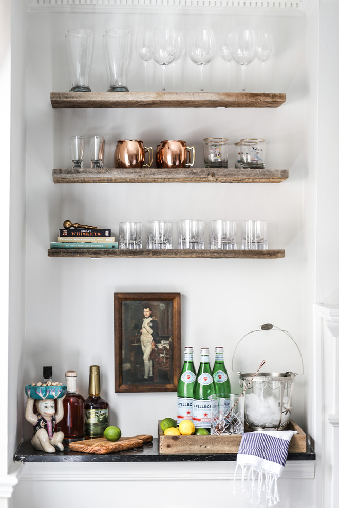 This is an example of a transitional single-wall home bar in Austin with medium wood cabinets, white splashback, no sink and soapstone benchtops.