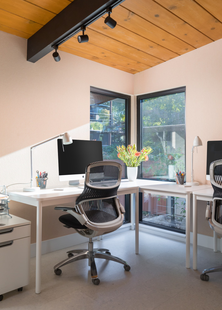 1950s freestanding desk gray floor, exposed beam, vaulted ceiling and wood ceiling home office photo in San Francisco with white walls