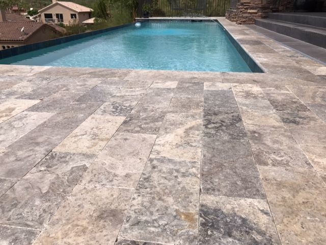 Mid-sized modern front yard rectangular lap pool in Phoenix with natural stone pavers.