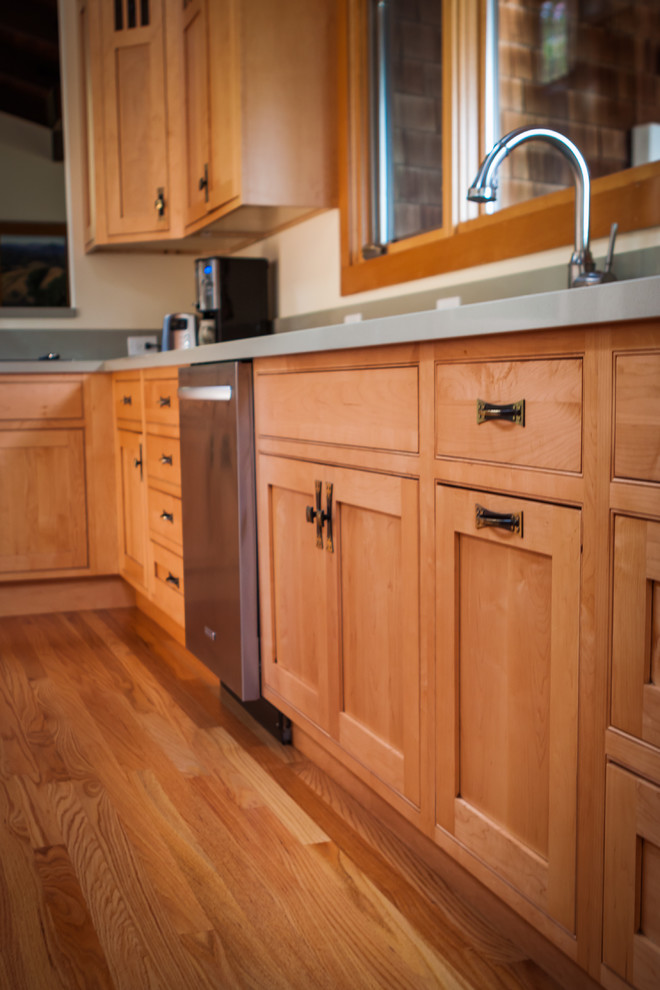 This is an example of a mid-sized arts and crafts l-shaped separate kitchen in San Francisco with a double-bowl sink, shaker cabinets, medium wood cabinets, quartzite benchtops, stainless steel appliances, medium hardwood floors and with island.