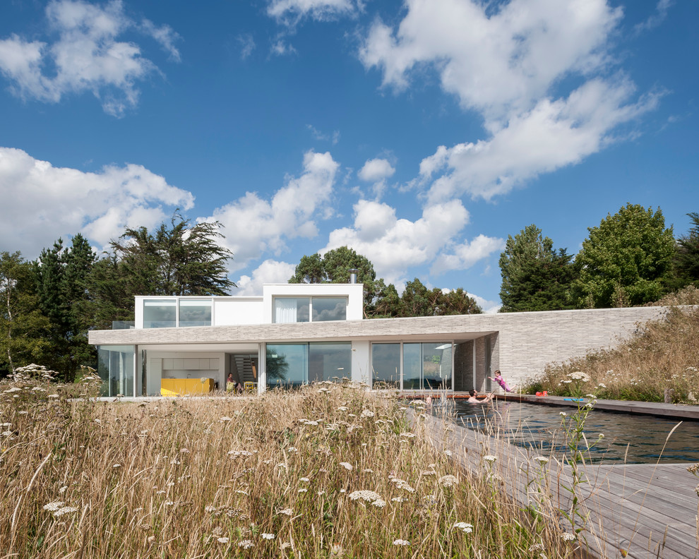 Contemporary two-storey brick white exterior in London with a flat roof.