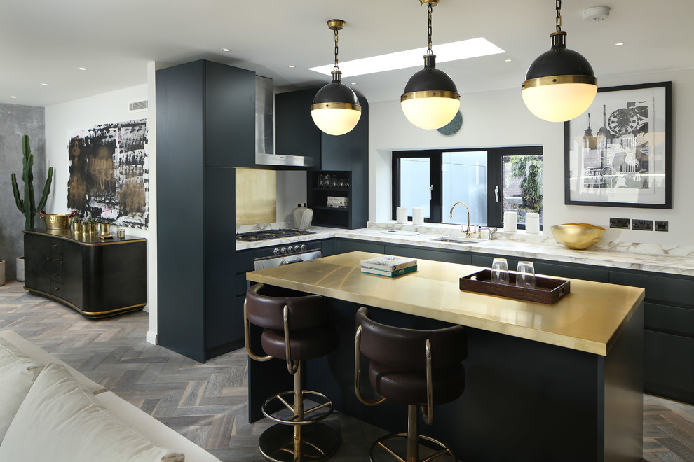 Inspiration for a contemporary l-shaped kitchen in London with an undermount sink, flat-panel cabinets, black cabinets, metallic splashback, metal splashback, medium hardwood floors and with island.