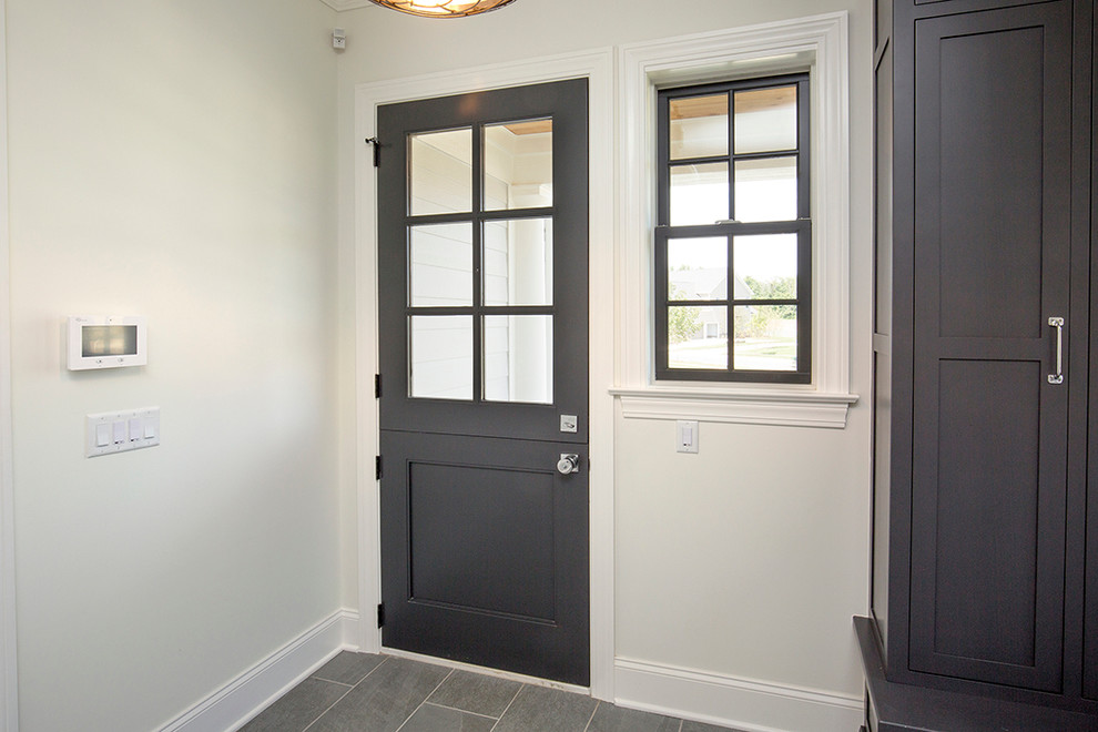 Mid-sized country front door in Columbus with white walls, concrete floors, a single front door and a gray front door.