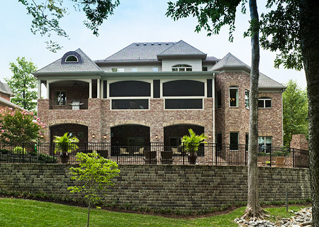Photo of a large traditional three-storey brick red exterior in Nashville with a gable roof.