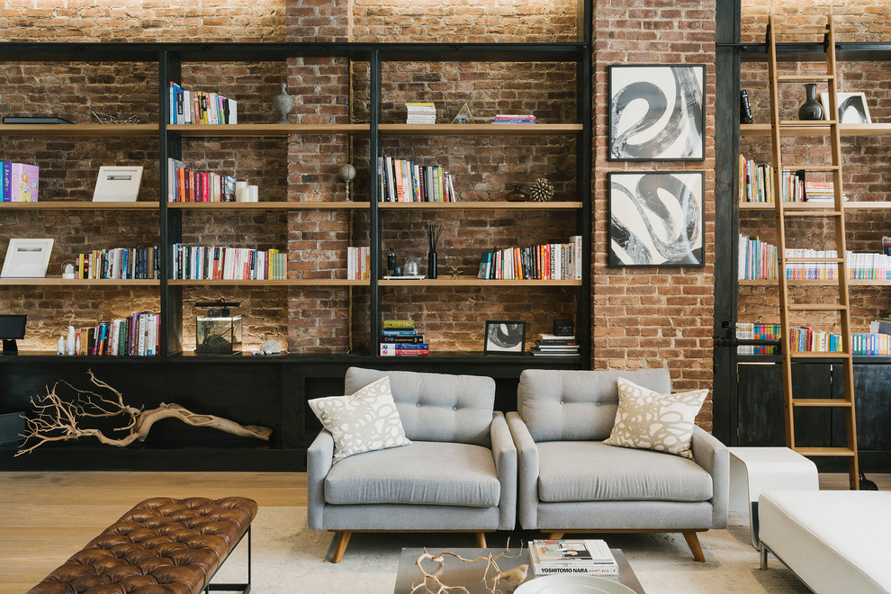 Design ideas for a large industrial open concept family room in New York with a library, light hardwood floors, white walls, no fireplace, no tv and beige floor.