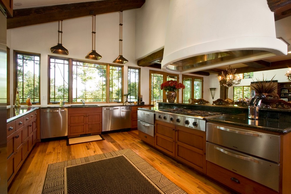 Inspiration for a large country u-shaped eat-in kitchen in Other with a double-bowl sink, recessed-panel cabinets, medium wood cabinets, granite benchtops, stainless steel appliances, medium hardwood floors and with island.
