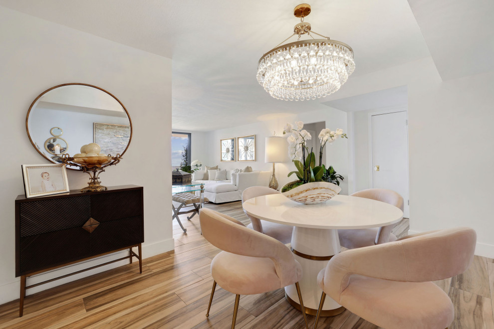 Photo of an expansive transitional dining room in Miami with white walls, porcelain floors and beige floor.
