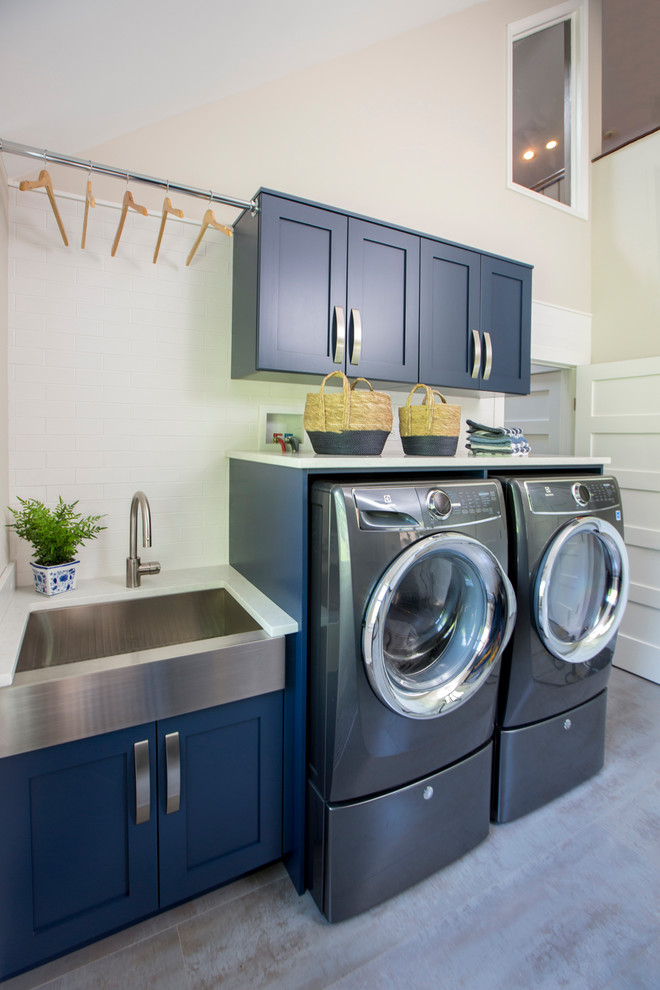 Inspiration for a mid-sized traditional u-shaped utility room in New York with an undermount sink, recessed-panel cabinets, blue cabinets, granite benchtops, beige walls, ceramic floors, a side-by-side washer and dryer, beige floor and white benchtop.