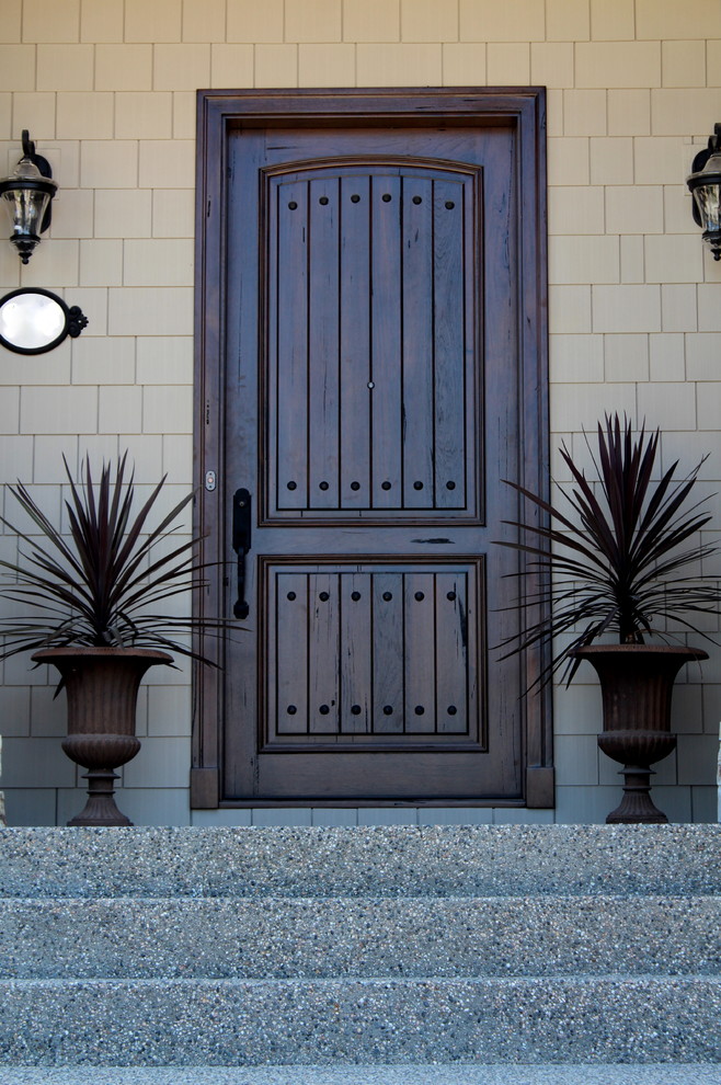 Inspiration for a mid-sized rustic front door remodel in Vancouver with a dark wood front door and beige walls