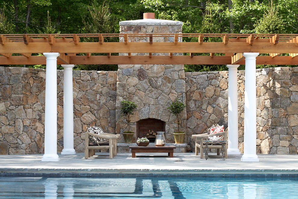 Photo of a large traditional backyard patio in New York with a pergola, a fire feature and concrete pavers.