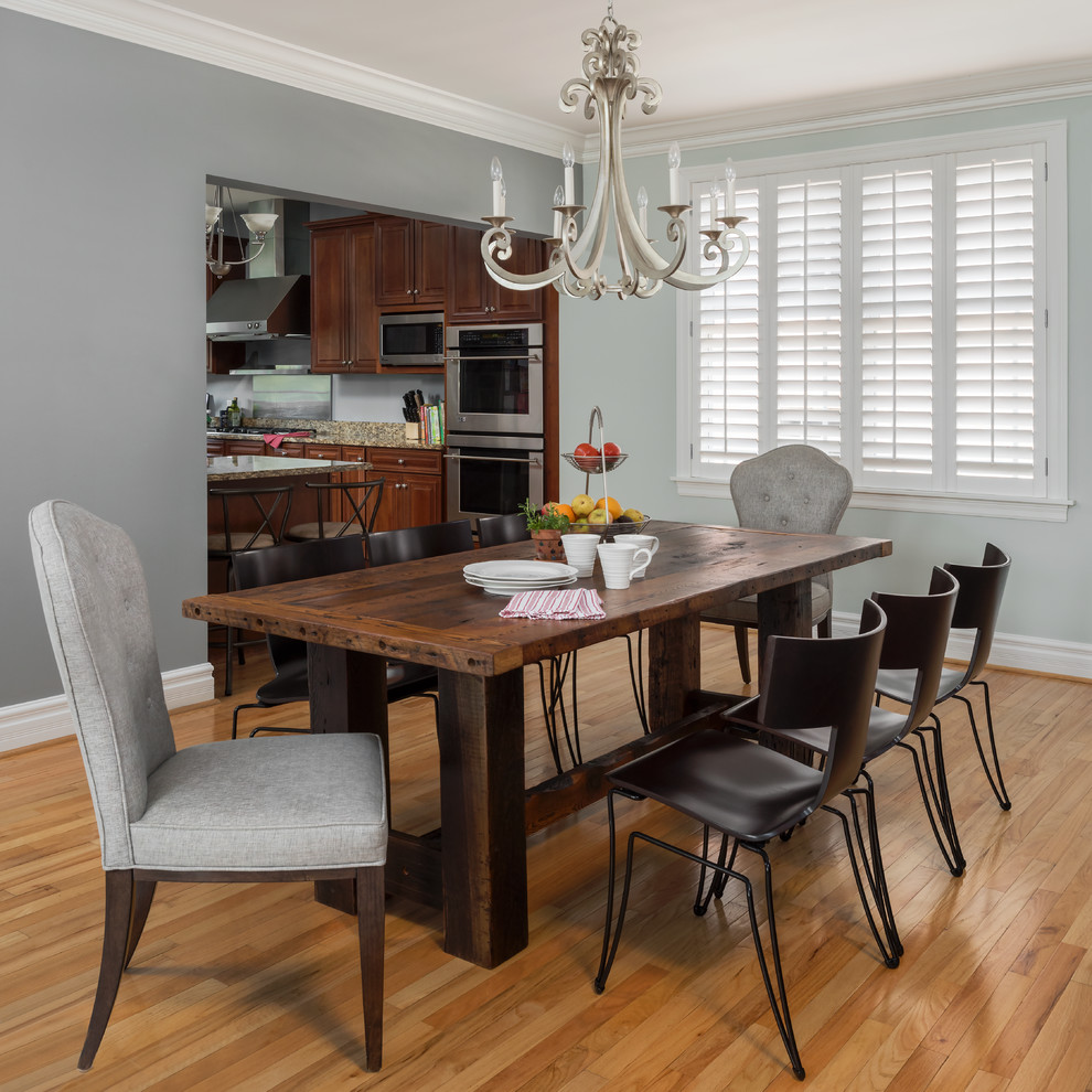 This is an example of a mid-sized country open plan dining in St Louis with grey walls, medium hardwood floors and orange floor.
