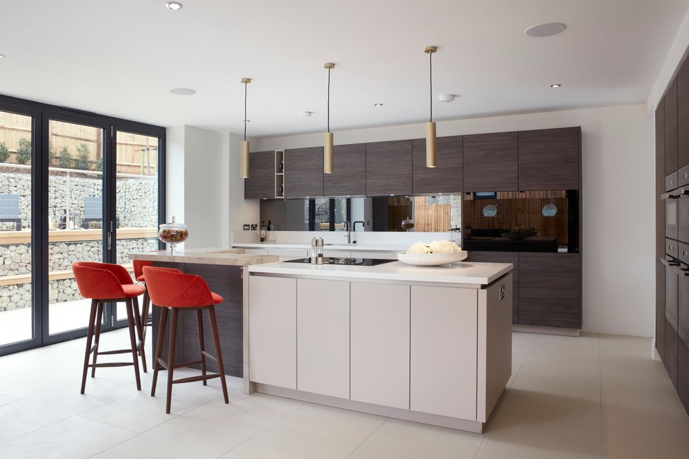 Photo of a large contemporary u-shaped kitchen in Kent with black appliances, with island, white floor, white benchtop, flat-panel cabinets and brown cabinets.