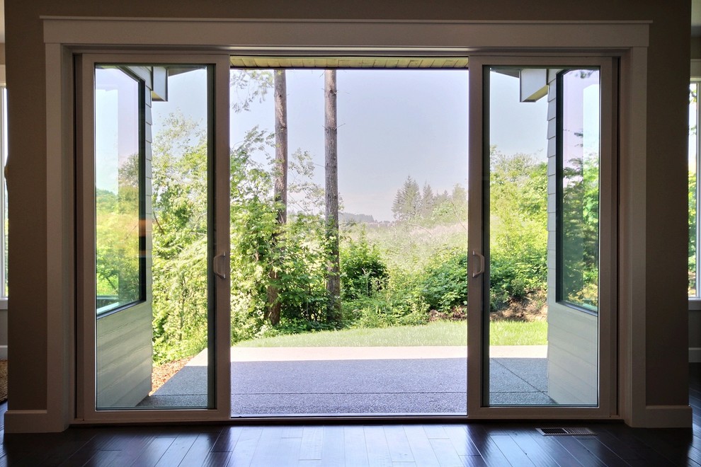 Photo of an expansive contemporary backyard patio in Portland with concrete slab and a roof extension.