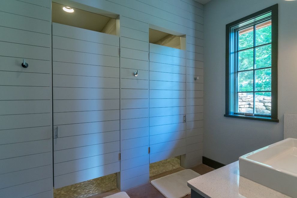 Mid-sized country kids bathroom in Birmingham with shaker cabinets, green cabinets, an open shower, a one-piece toilet, gray tile, porcelain tile, green walls, concrete floors, a trough sink, engineered quartz benchtops, orange floor and a hinged shower door.