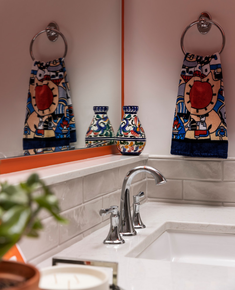 This is an example of a mid-sized eclectic bathroom in Detroit with blue cabinets, gray tile, orange walls, grey floor, white benchtops and a double vanity.